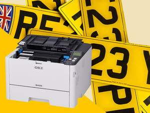 OKI mono printer surrounded by yellow UK car number plates