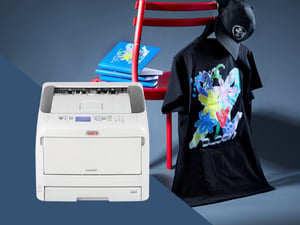 OKI Pro8432WT transfer printer with a transfer-printed T-shirt and cap