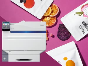 OKI Pro9542 printer with printed snack pouches, dried orange slices and dragon fruit